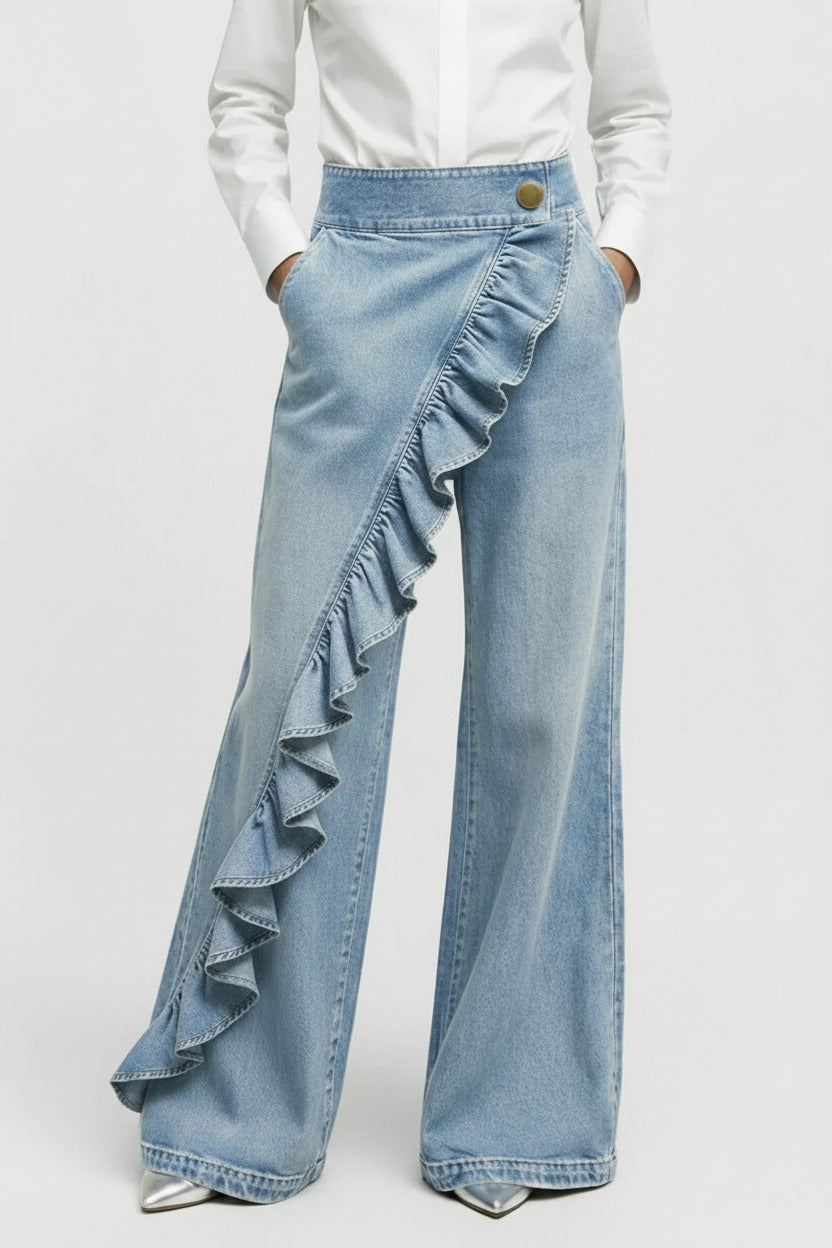 Light blue denim pants with ruffles on a gray background