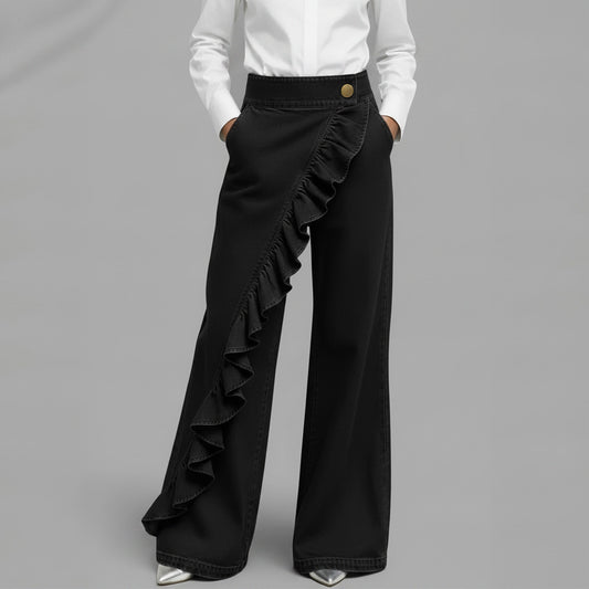 Person wearing wide-leg gray pants with a plain background